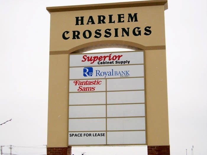 A monument sign with the names and logos of multiple businesses, representing how one can benefit from calling a Plainfield, IL sign company.