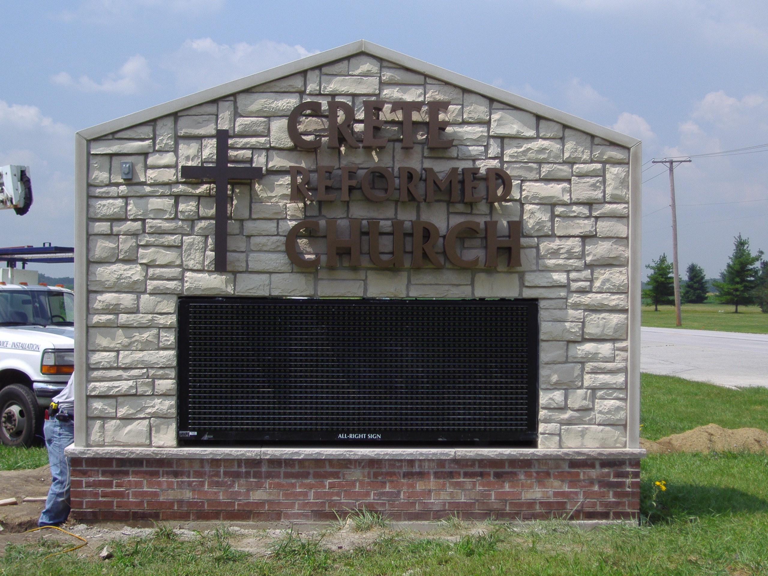 A beige, digital sign for a church, representing how one can benefit from calling a Joliet, IL digital sign company.