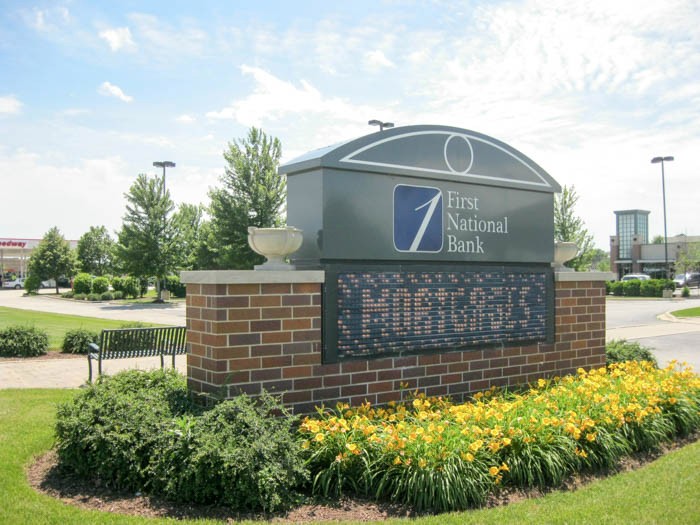 A monument, digital sign outside of a bank, representing how one can benefit from calling a Merrillville, IN commercial sign company.