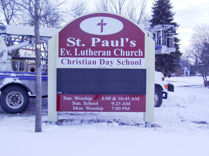 A digital sign outside of a church being installed on a snowy day, representing how one can benefit from calling a Lake County, IN digital sign company.