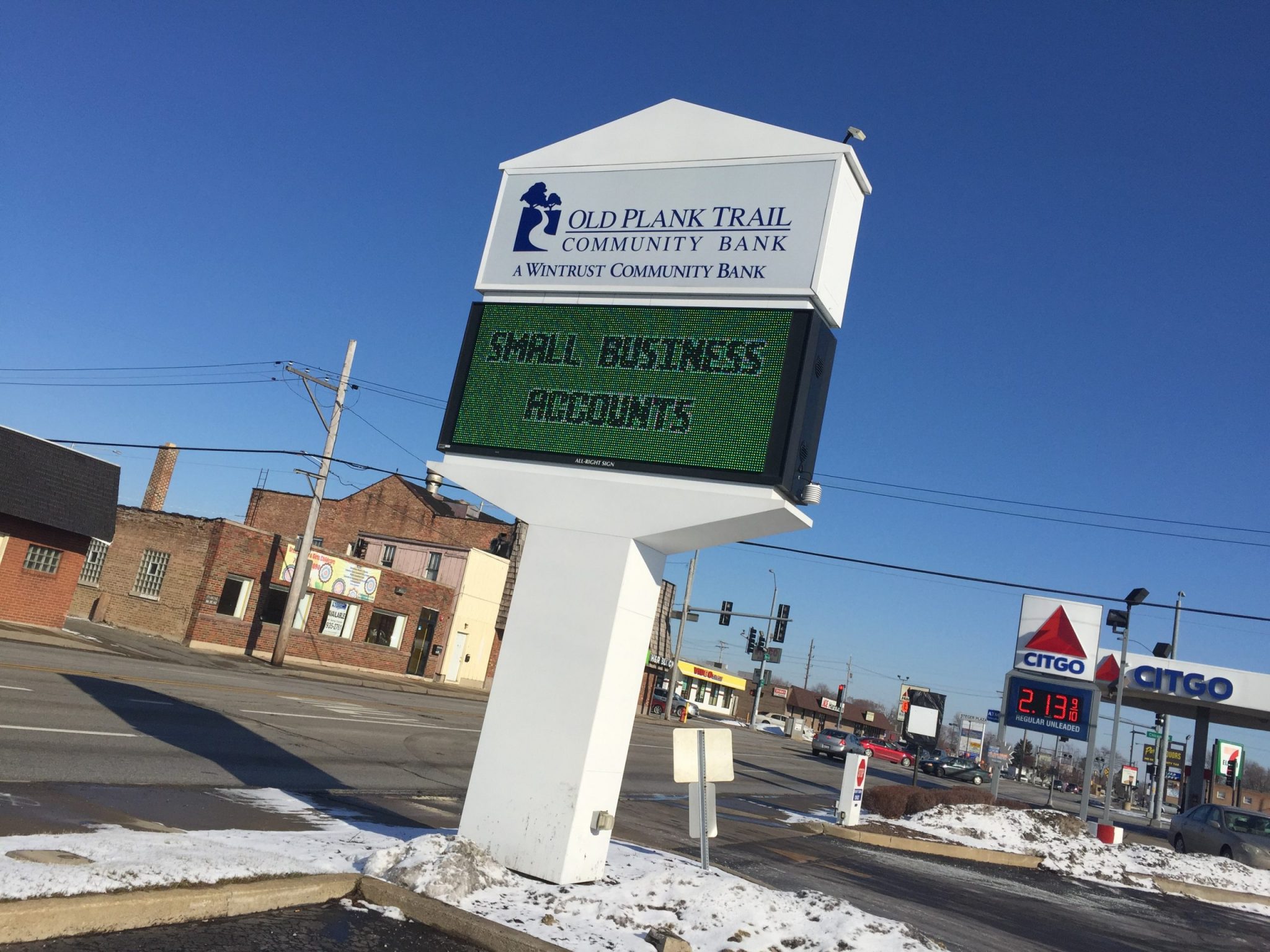 A white, outdoor digital sign for a bank, representing how one can benefit from calling a Cook County, IL digital sign company.
