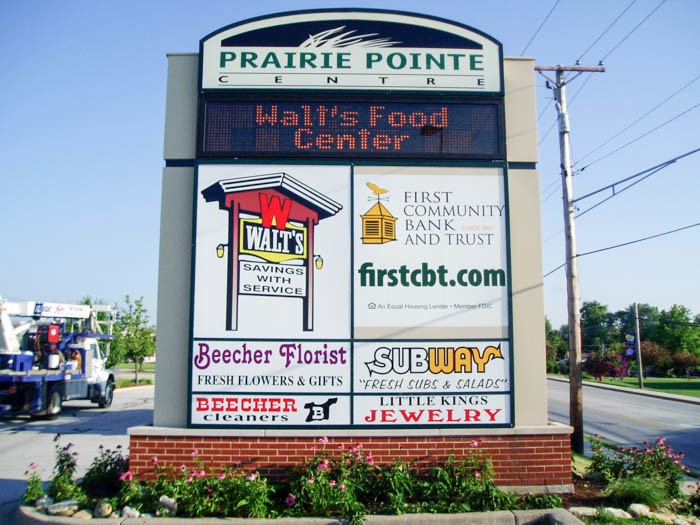 A monument sign with the names and logos of multiple business, representing how one can benefit from calling an Orland Park commercial sign company.