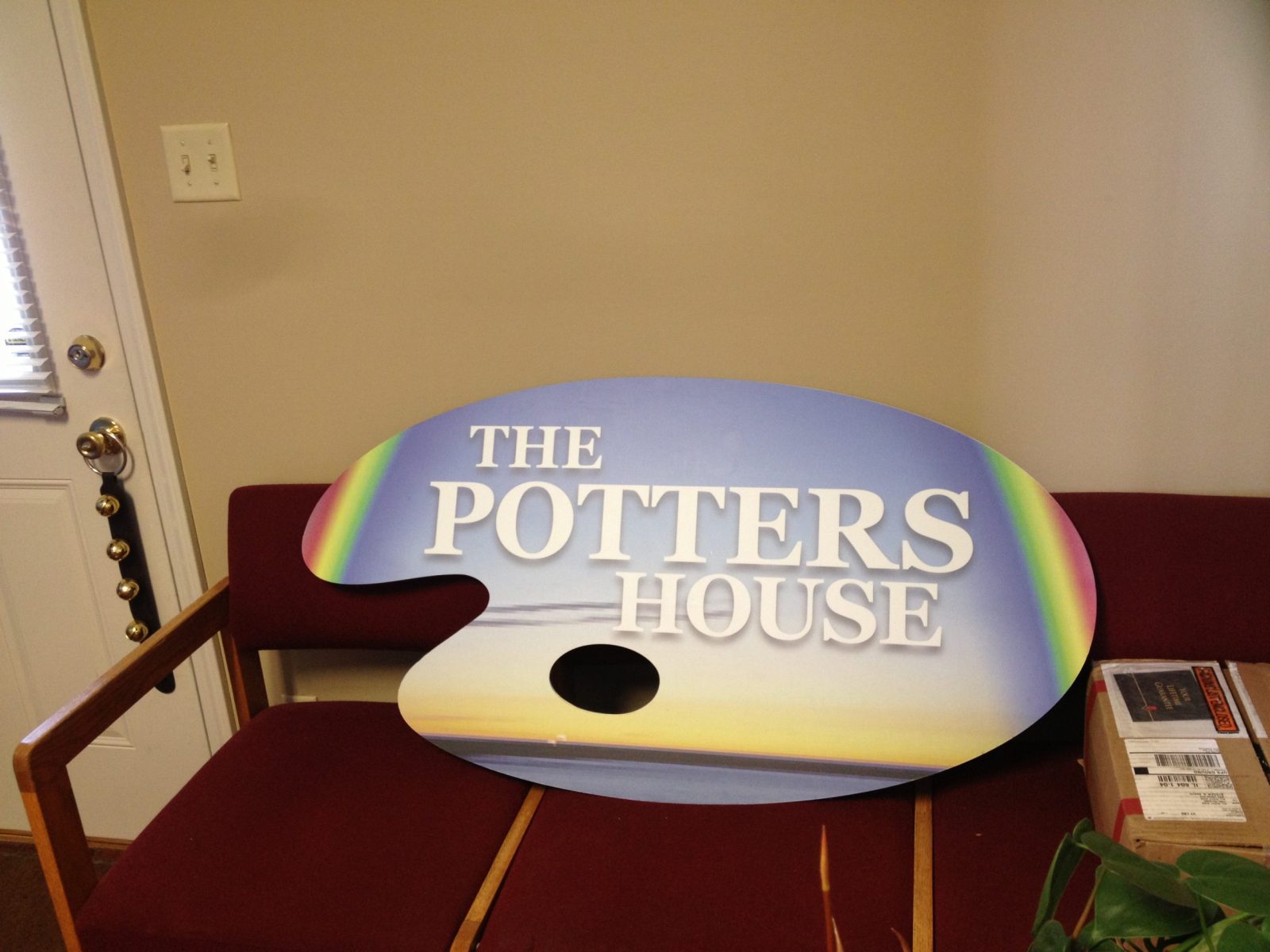 A colorful, indoor sign on top of a chair representing how one can benefit from calling a sign installation company in Plainfield, IL.
