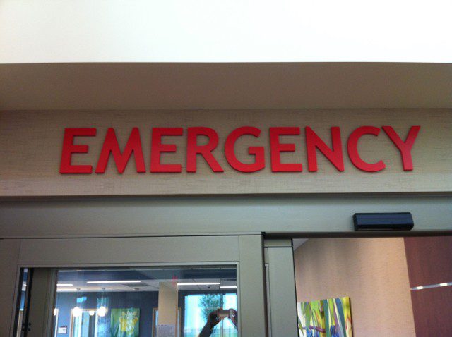 A dimensional sign with big red letters that say "Emergency", representing how one can benefit from calling a Chicago sign installation company.