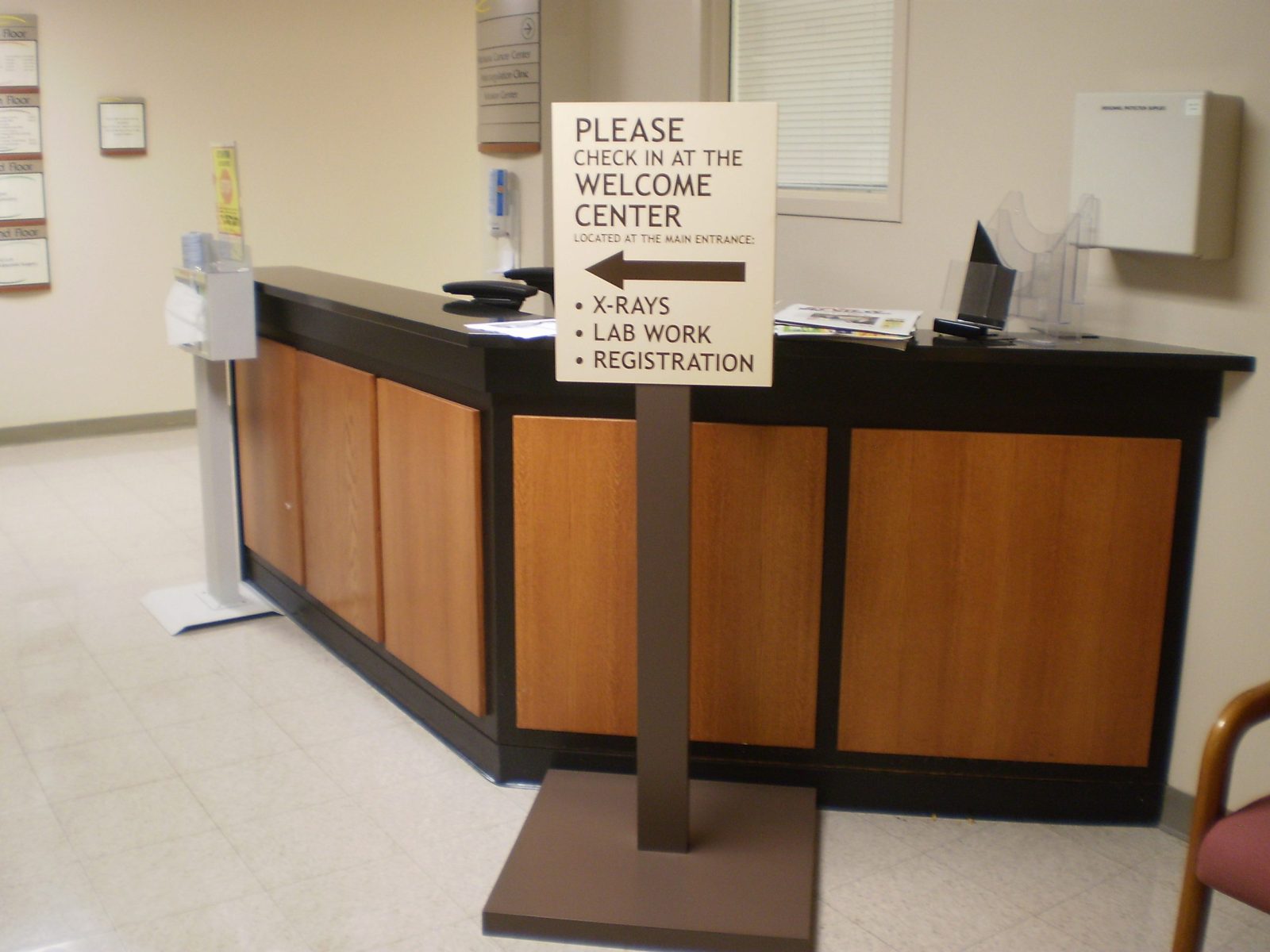 An interior sign by a receptionist desk that gives instructions on where to go, representing how one can benefit from calling a sign installation company in Plainfield, IL.