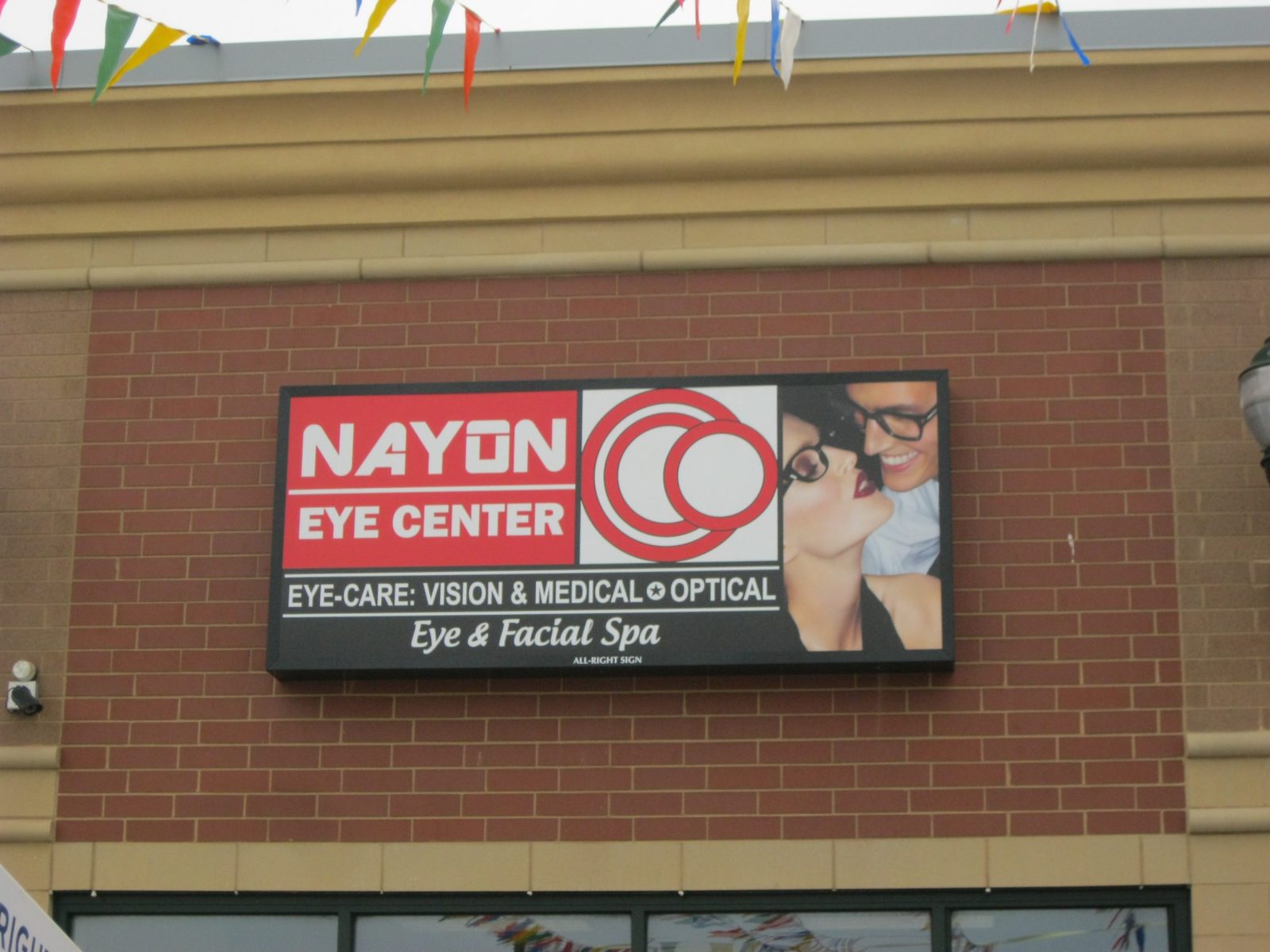 A large wall sign on a brick wall outside of a business, representing how one can benefit from calling a Joliet sign installation company.