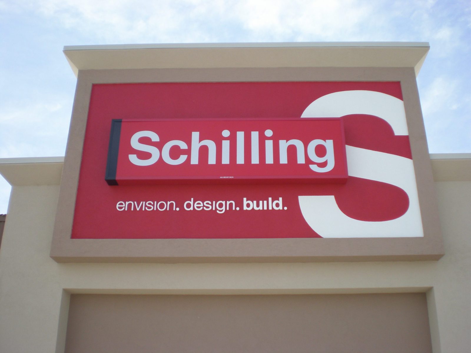 A big red sign with white letters on the outside wall of a business, representing how one can benefit from calling a Chicago sign installation company.