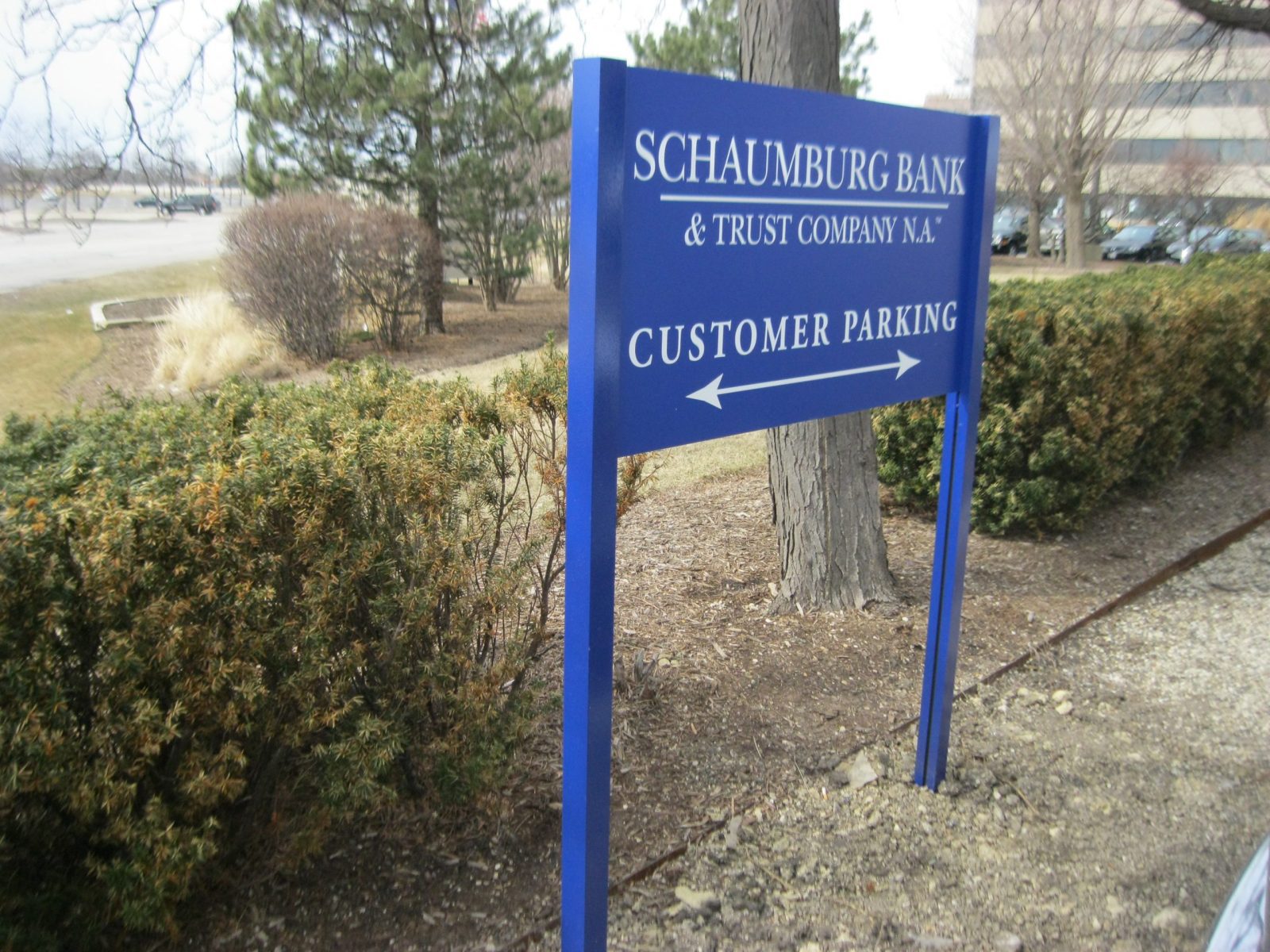 A blue post sign with white letters giving instructions to drivers, representing how one can benefit from calling a Joliet sign company.