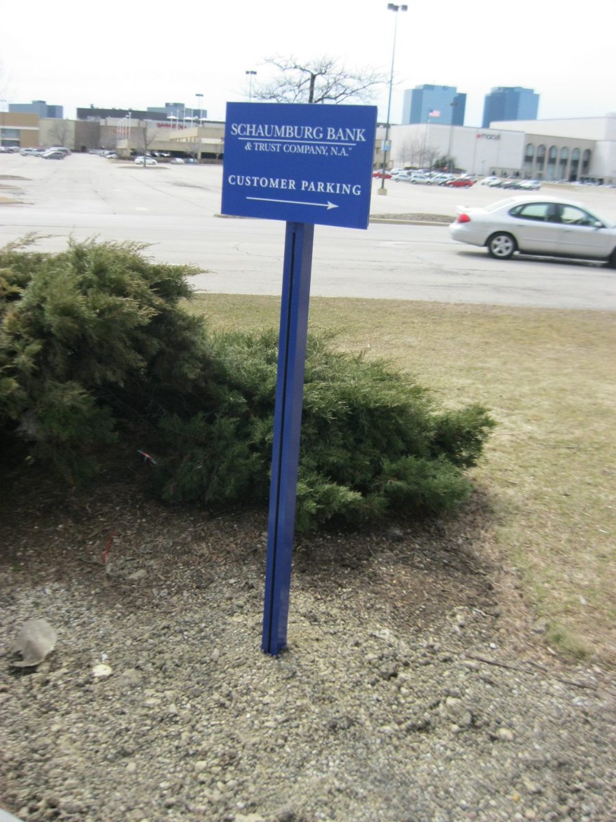A blue post sign with white letters giving instructions to drivers, representing how one can benefit from calling an Orland Park sign company.