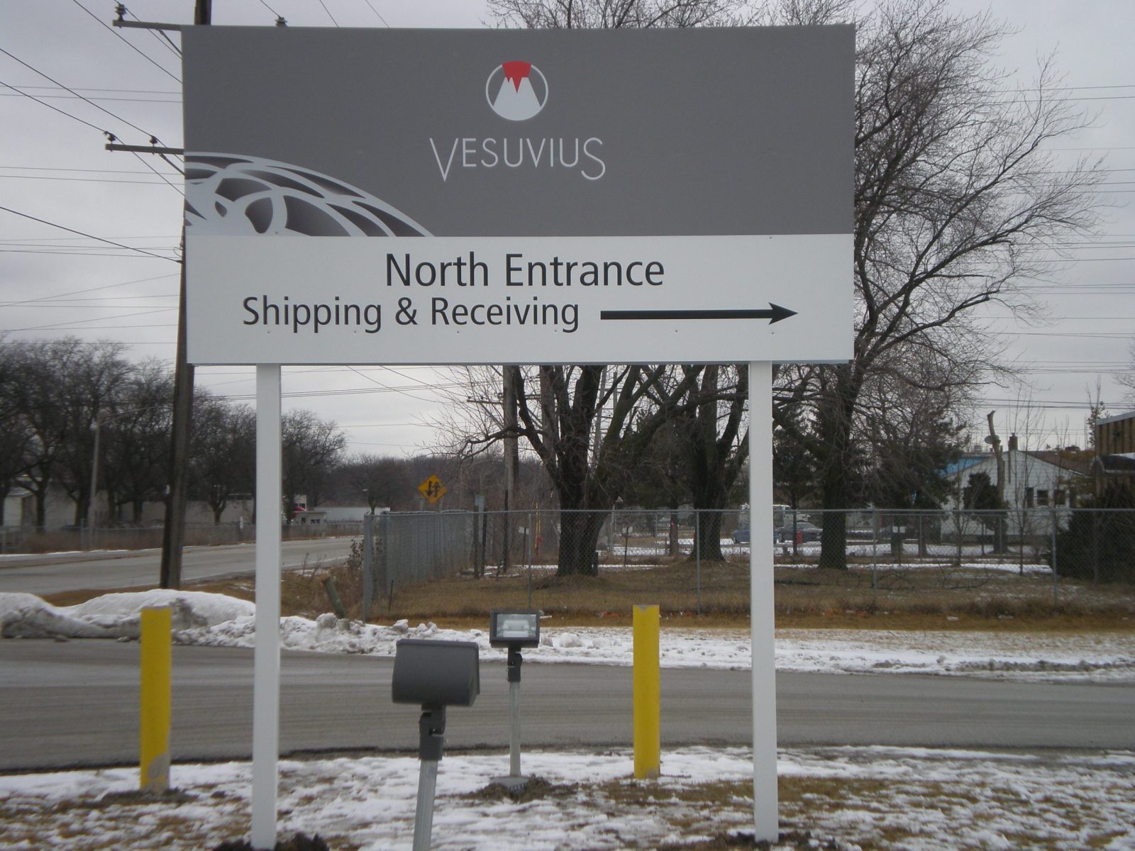 A panel white and gray sign giving directions to drivers, representing how one can benefit from calling a Merrillville sign company.