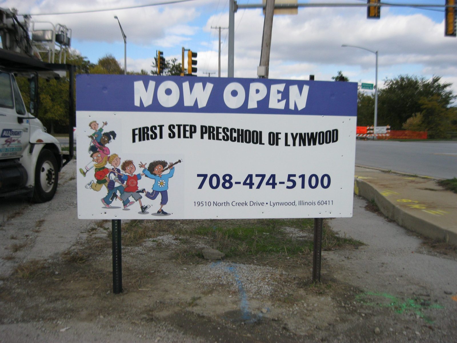 A white and blue post sign on the side of the street, representing how one can benefit from calling a Plainfield, IL sign company.