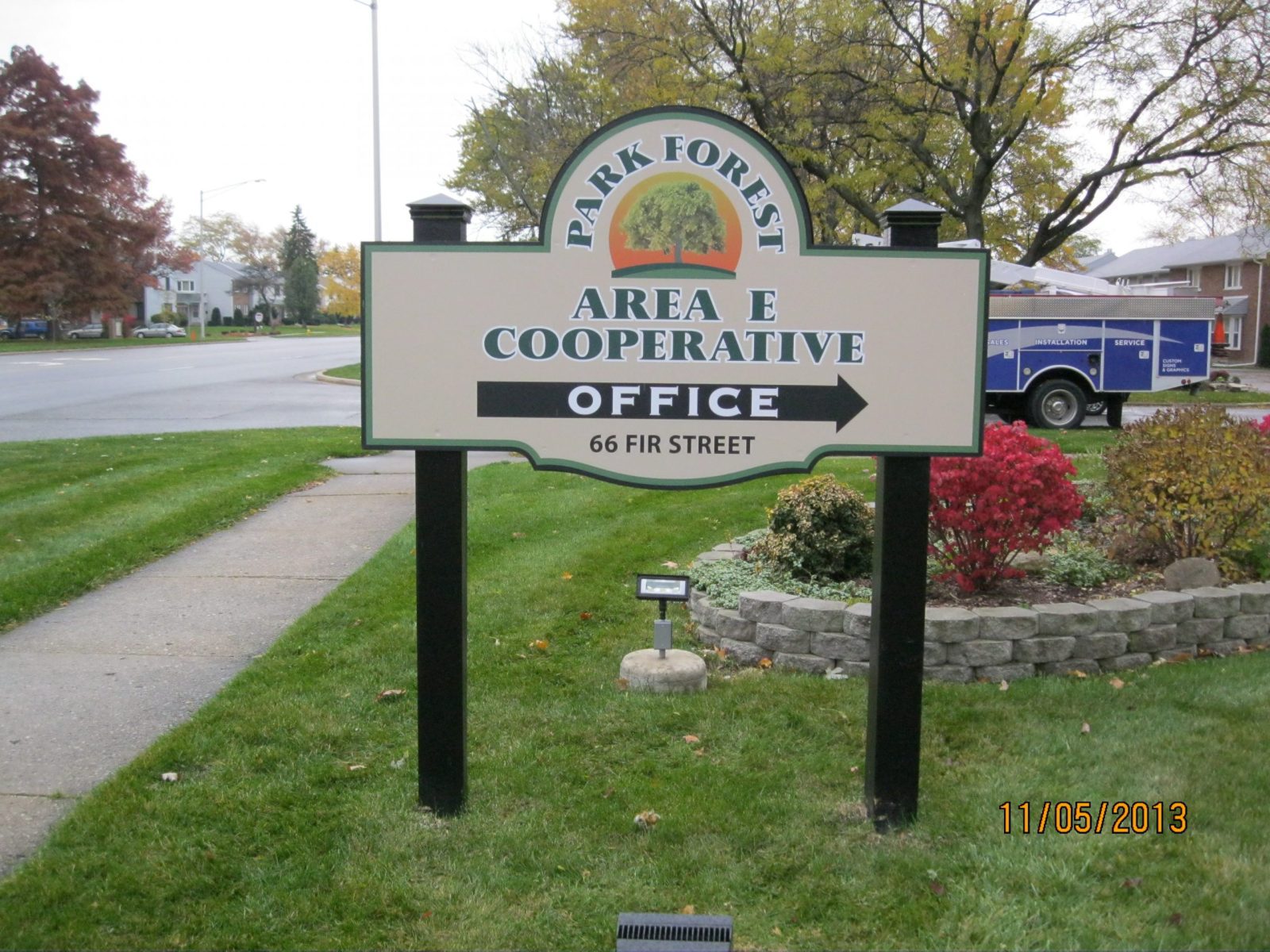 An outdoor post sign with instructions on how to get to the office, representing how one can benefit from calling a Plainfield, IN sign company.