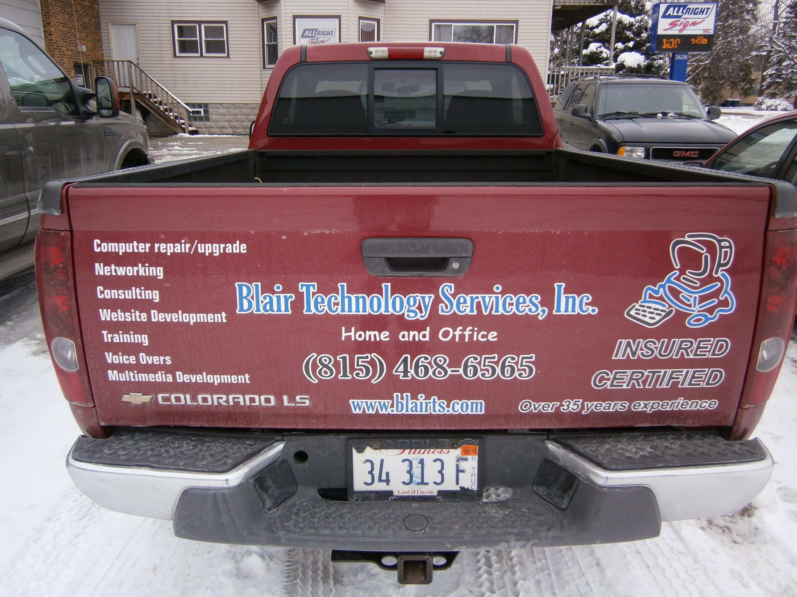 A red truck with multiple graphic fleets, representing how one can benefit from calling a Tinley Park commercial truck lettering company.