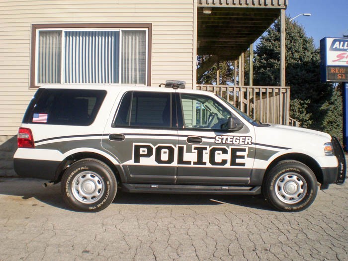 A police SUV vehicles with graphic fleets, representing how one can benefit from calling a Cook County, IL commercial truck lettering company.