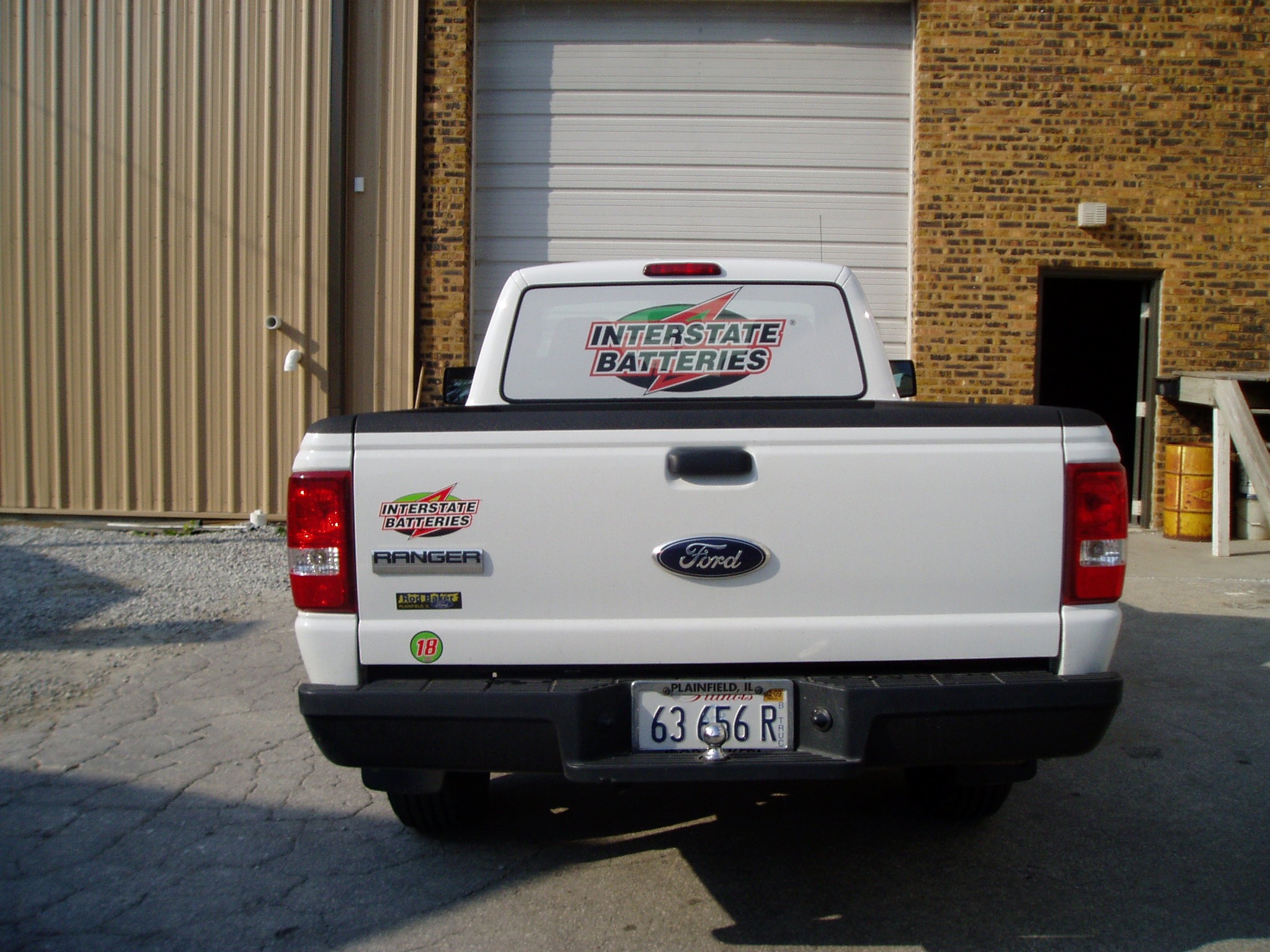 A white truck with fleet graphics, representing how one can benefit from calling a Chicago commercial truck lettering company.