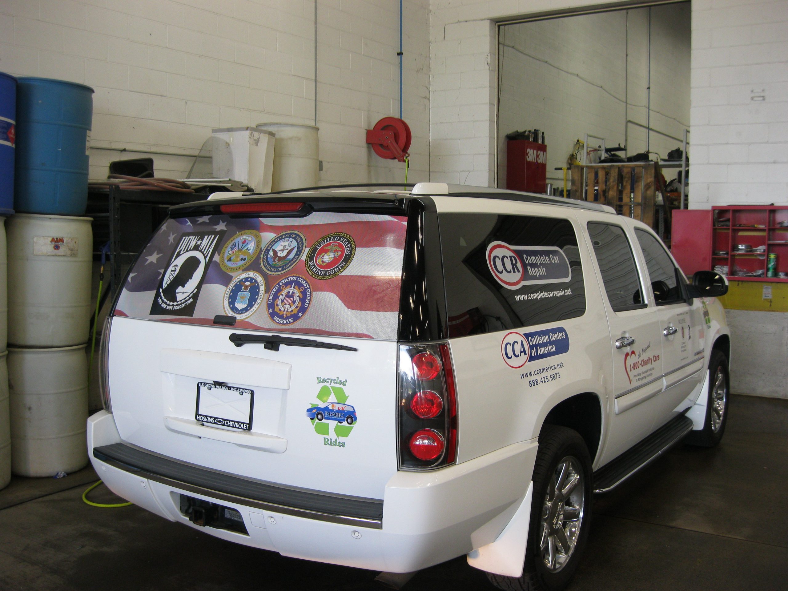 A white SUV with fleet graphics all over, representing how one can benefit from calling a Chicago commercial truck lettering company.