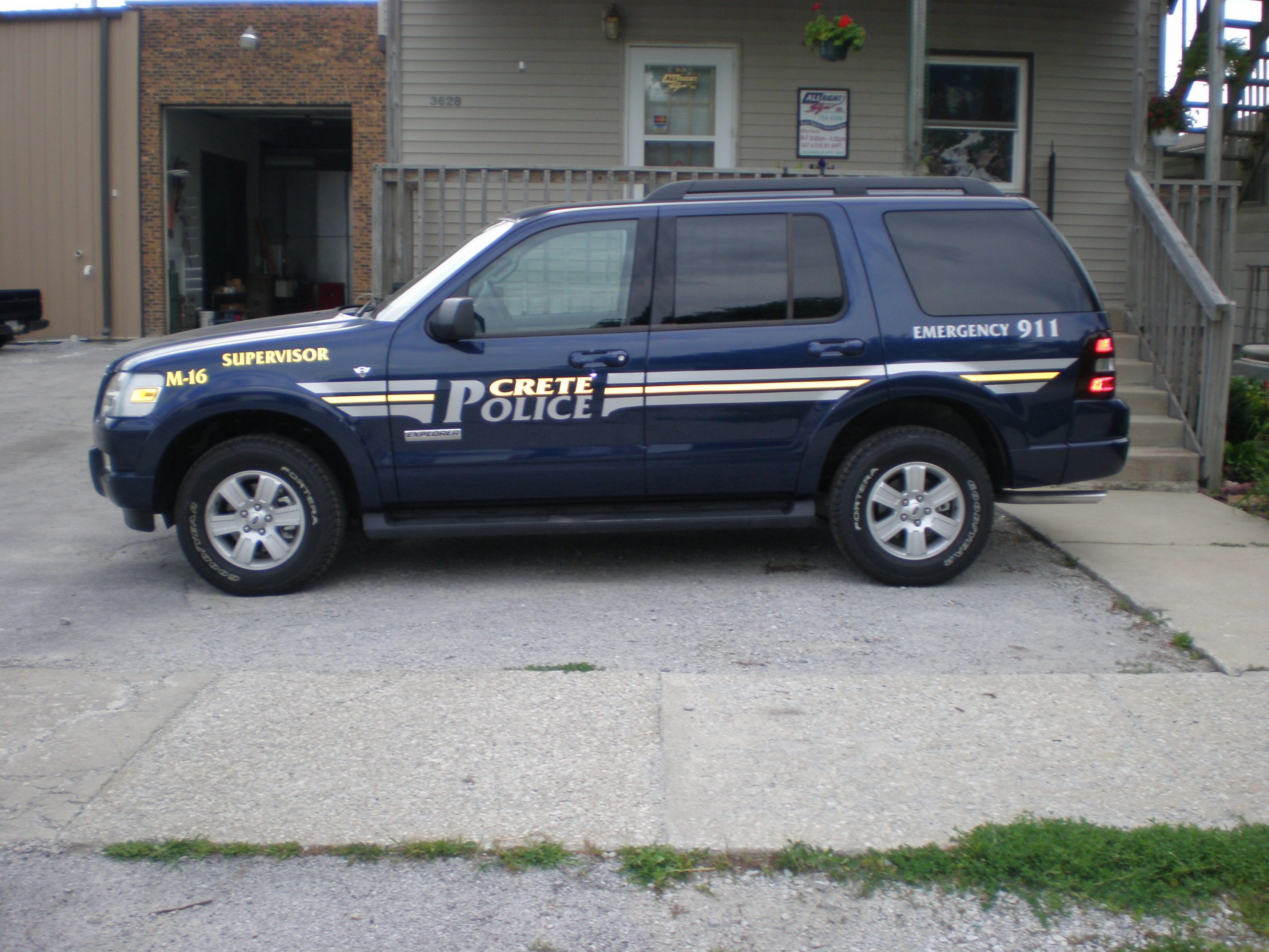 A dark SUV police vehicle with graphic fleet designs, representing how one can benefit from calling a Lake County, IN commercial truck lettering company.