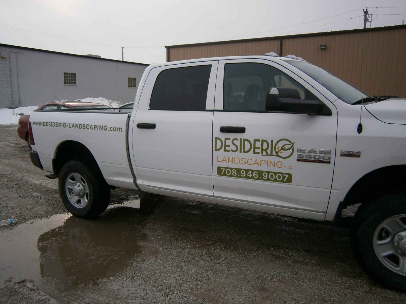 A white pickup truck with graphic fleet on the driver's door, representing how one can benefit from calling an Orland Park commercial truck lettering company.