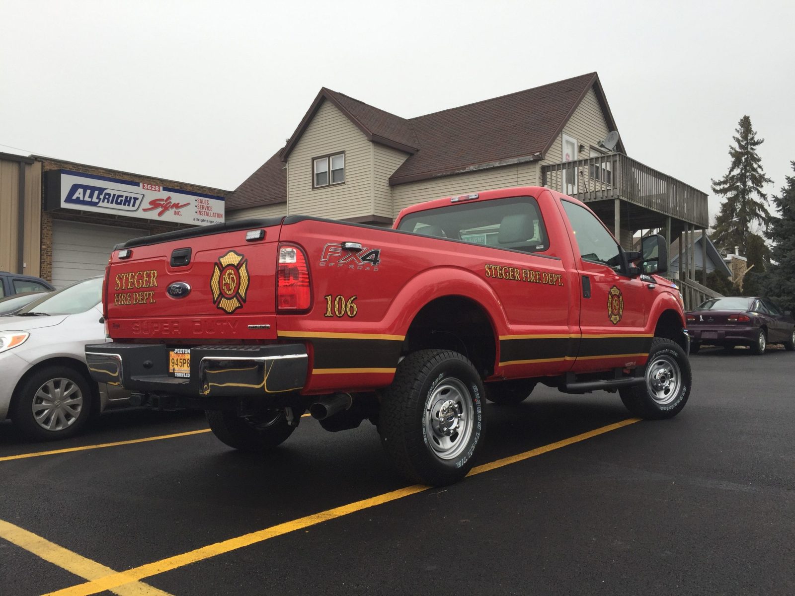 A red truck with multiple graphic fleets, representing how one can benefit from calling a Plainfield, IL commercial truck lettering company.