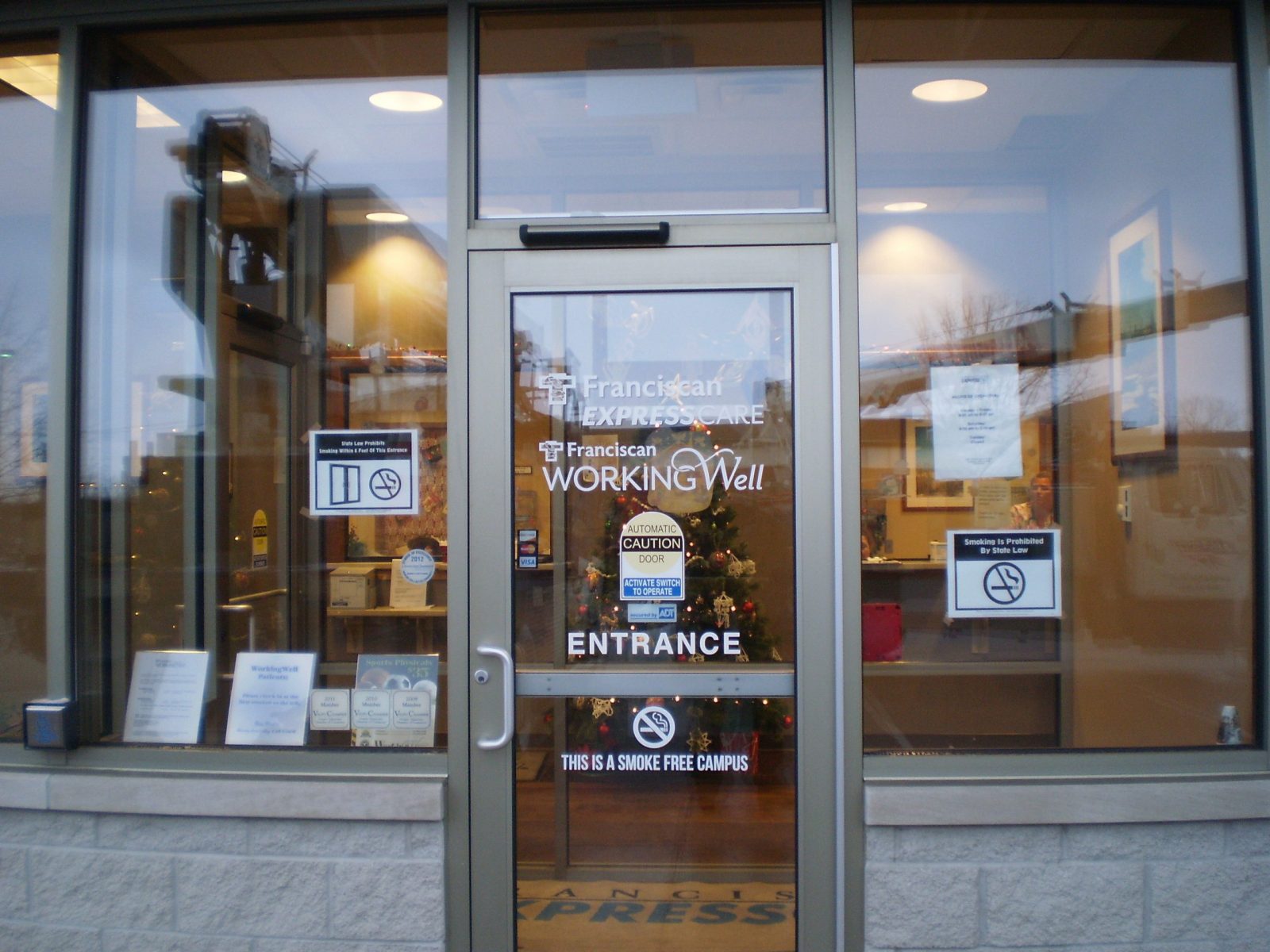 The entrance door of a hospital with white graphics printed on it, representing how one can benefit from calling a sign company in Lake County, IN.