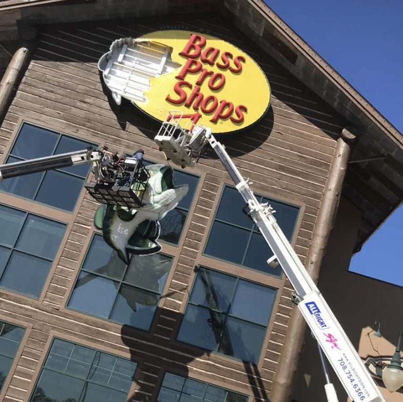 The outside of a business with a large sign being installed, representing how one can benefit from calling a Merrillville commercial sign company.