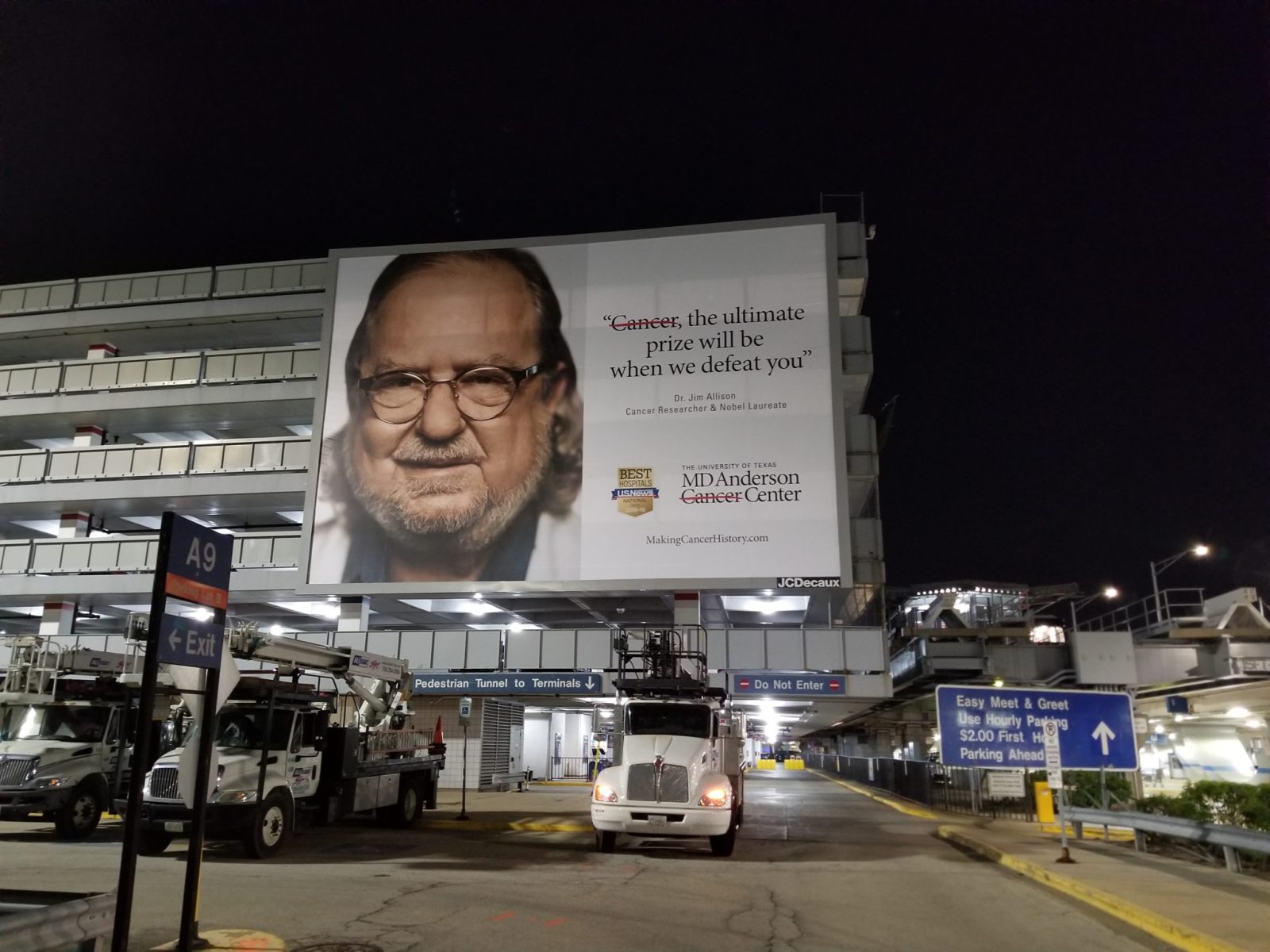 A large picture of a parking lot with a giant billboard size sign with the picture of a doctor, representing how one can benefit from calling the best Chicago commercial sign company.