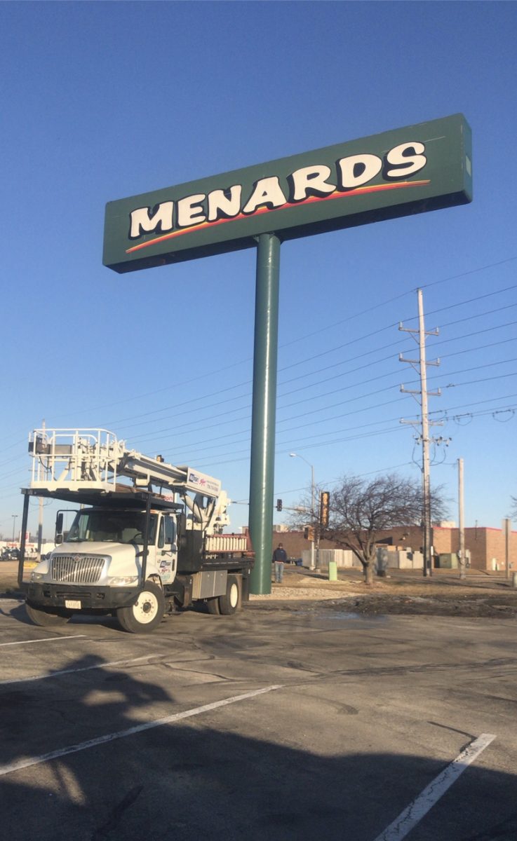 A truck in the parking lot of a business after fixing a sign, representing how one can benefit from calling a Tinley park commercial sign company.